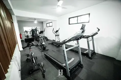 a gym with several tread machines in a room at Fj Luxury Apartment in Santiago de los Caballeros