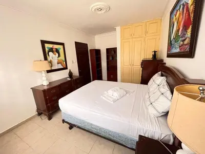 a bedroom with a large white bed in a room at Estancia Marina 101 in Boca Chica