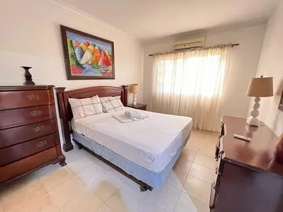 a bedroom with a bed and a dresser and a window at Estancia Marina 101 in Boca Chica