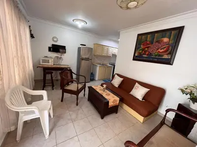 a living room with a couch and a table at Estancia Marina 101 in Boca Chica