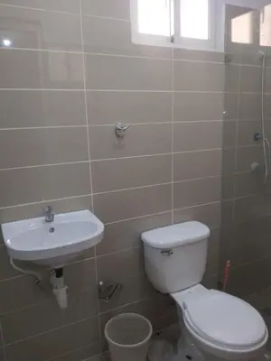 a bathroom with a toilet and a sink at Villa club turístico tu ancla in Los Alcarrizos