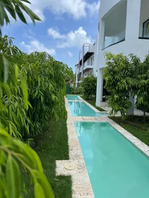 an image of a swimming pool next to a building at Swim up and Beach Getaway at White Sands in Punta Cana