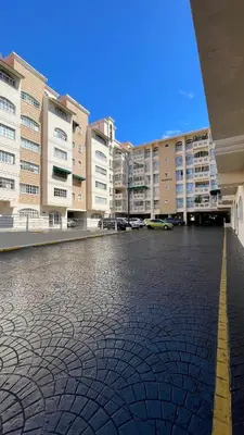 an empty parking lot in front of apartment buildings at Relaxing and cozy apartment in Gazcue in Santo Domingo