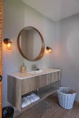 a bathroom with a sink and a mirror at Bayshore 76 Beachfront Villa Palmar de ocoa in Palmar de Ocoa