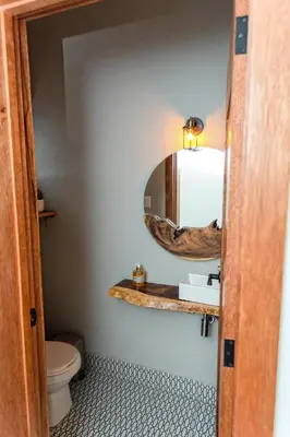 a bathroom with a sink and a mirror at Bayshore 76 Beachfront Villa Palmar de ocoa in Palmar de Ocoa