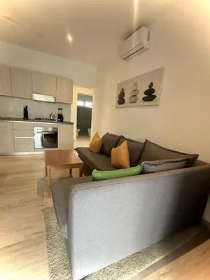a living room with a couch and a kitchen at Modern apartament near the sea-Las Terrenas in Las Terrenas