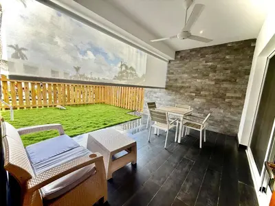 a room with a patio with a table and chairs at Modern apartament near the sea-Las Terrenas in Las Terrenas