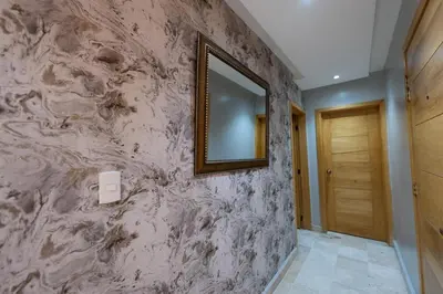a mirror on a wall next to a hallway at City Center, 2-BR Suite close to Shops, Restaurants, Bars and More in Santo Domingo