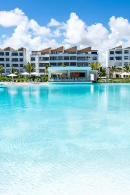 a large swimming pool in front of a resort at PB 3 hab | con piscina privada + laguna cristalina in Punta Cana