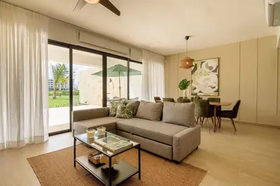 a living room with a couch and a table at PB 3 hab | con piscina privada + laguna cristalina in Punta Cana