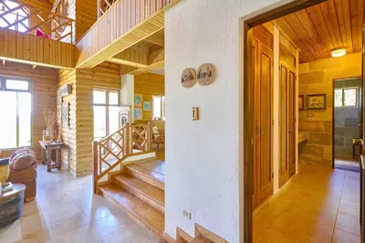 a room with a staircase in a wooden house at ®4BR{Wood~Mountain~Villa} @Jarabacoa Heated Pool in Jarabacoa