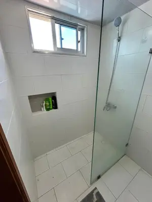 a bathroom with a glass shower with a window at Luxury Pool Gym Basketball in Santiago de los Caballeros