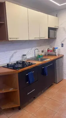 a kitchen with a sink and a stove top oven at Atardecer Albatros in Juan Dolio