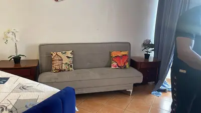 a living room with a couch with pillows on it at Atardecer Albatros in Juan Dolio