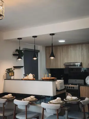 a kitchen with a table with chairs and a counter at Amor in Punta Cana