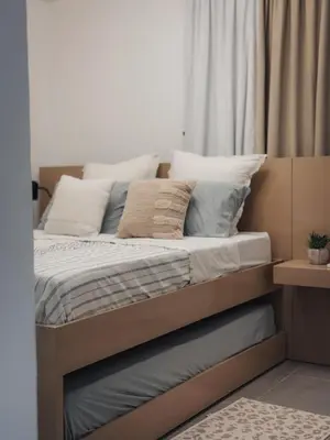 a bed with pillows on it in a bedroom at Amor in Punta Cana