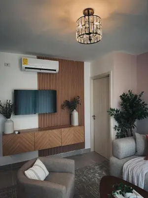 a living room with a tv and a couch at Amor in Punta Cana