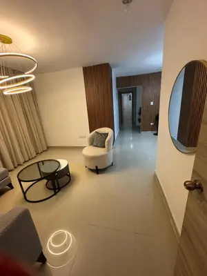 a living room with a chair and a table at Apartamento deluxes en Bonao in Bonao