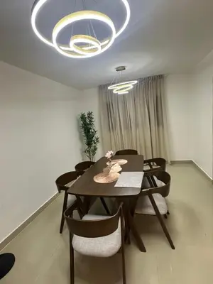 a dining room with a table and chairs under a chandelier at Apartamento deluxes en Bonao in Bonao