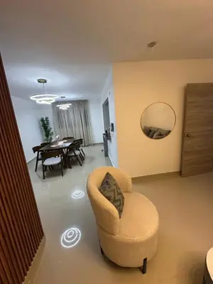 a living room with a chair and a table at Apartamento deluxes en Bonao in Bonao