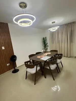 a dining room with a table and some chairs at Apartamento deluxes en Bonao in Bonao
