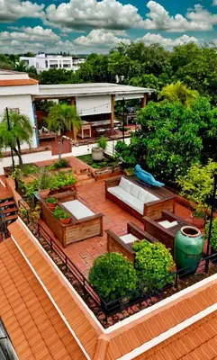 an overhead view of a patio with benches and trees at Lux 2-Level Townhouse with Stunning Historic Views in Santo Domingo