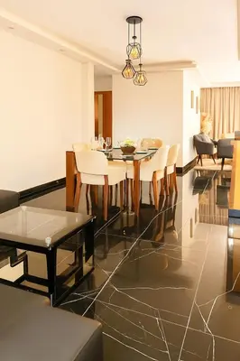 a dining room and living room with a table and chairs at Comfortable and Attractive Apartment in Ensanche Savica de Mendoza