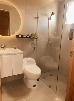 a bathroom with a toilet and a shower and a sink at Comfortable and Attractive Apartment in Ensanche Savica de Mendoza