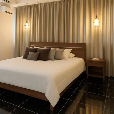 a bedroom with a large bed with white sheets and pillows at Comfortable and Attractive Apartment in Ensanche Savica de Mendoza