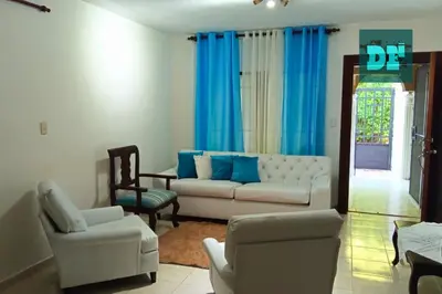 a living room with a white couch and chairs at Villa Eli in Puerto Plata