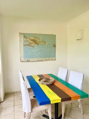 a dining room table with chairs and a map on the wall at Apartment 5 Mins Walk To The Beach