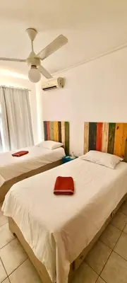 a bedroom with two beds and a ceiling fan at Apartment 5 Mins Walk To The Beach