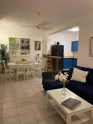 a living room with a couch and a table at Apartment 5 Mins Walk To The Beach