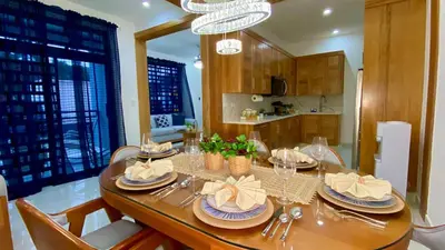 a dining room with a table with plates and glasses at Zarzuela Villas del Mar Puerto Plata in Muñoz