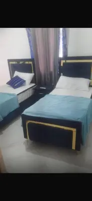 two twin beds in a bedroom with a window at santo domingo airport villa in Reparto Esther Rosario