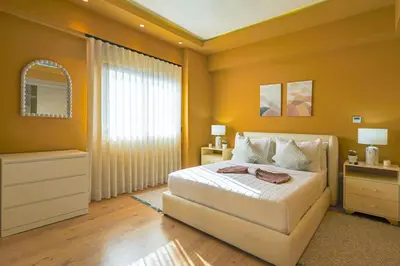 a bedroom with a white bed and a window at Elegant and Cozy 1BD Condo in Santo Domingo