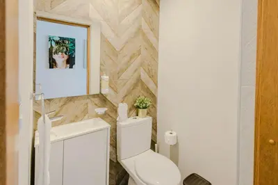 a bathroom with a toilet and a sink at Chic Elegant City Center Condo in Santo Domingo
