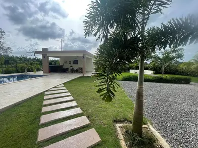 a palm tree in front of a house at Jeda Village in Higuey