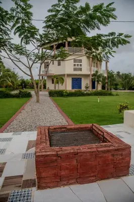 a brick fire pit in front of a house at Jeda Village in Higuey