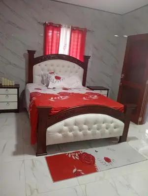a bedroom with a bed with a cat laying on it at Villa colombia in Miches