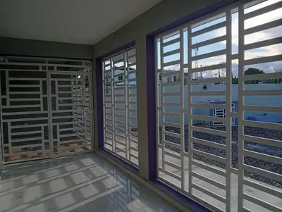 a room with two windows and views of the water at Villa colombia in Miches