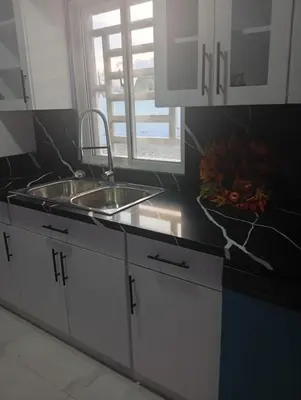 a kitchen counter with a sink and a window at Villa colombia in Miches