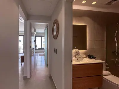 a bathroom with a sink and a mirror at Beautiful brand new Beach Condo w Picuzzi in Punta Cana
