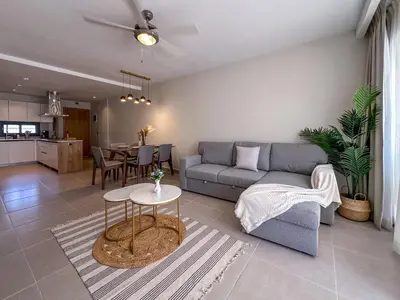 a living room with a couch and a table at Beautiful brand new Beach Condo w Picuzzi in Punta Cana