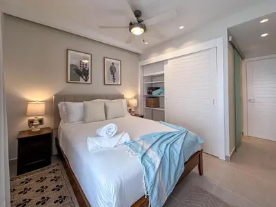 a bedroom with a bed with two towels on it at Beautiful brand new Beach Condo w Picuzzi in Punta Cana