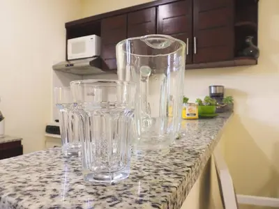 a group of glasses sitting on a counter in a kitchen at Majestic View Apartment II in San Felipe de Puerto Plata