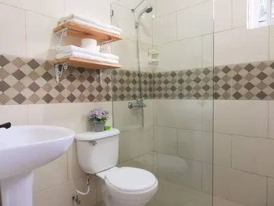 a bathroom with a toilet and a sink and a shower at Majestic View Apartment II in San Felipe de Puerto Plata