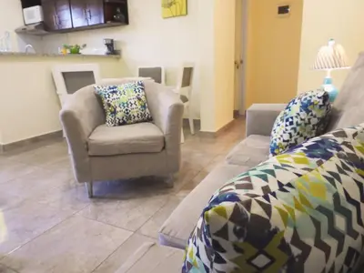 a living room with a couch and a chair at Majestic View Apartment II in San Felipe de Puerto Plata