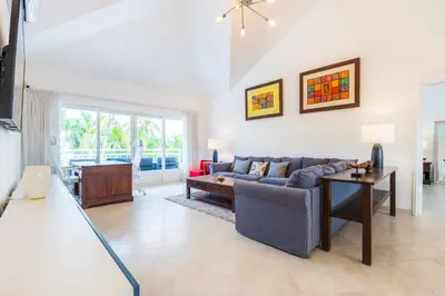 a living room with a couch and a table at Buganvilla 252 Cocotal Villa - 4BR, Private Pool, Jacuzzi, Golf View in Punta Cana