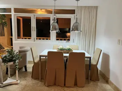 a dining room with a table and chairs at Antiguo Dominican Bay in Cuevas